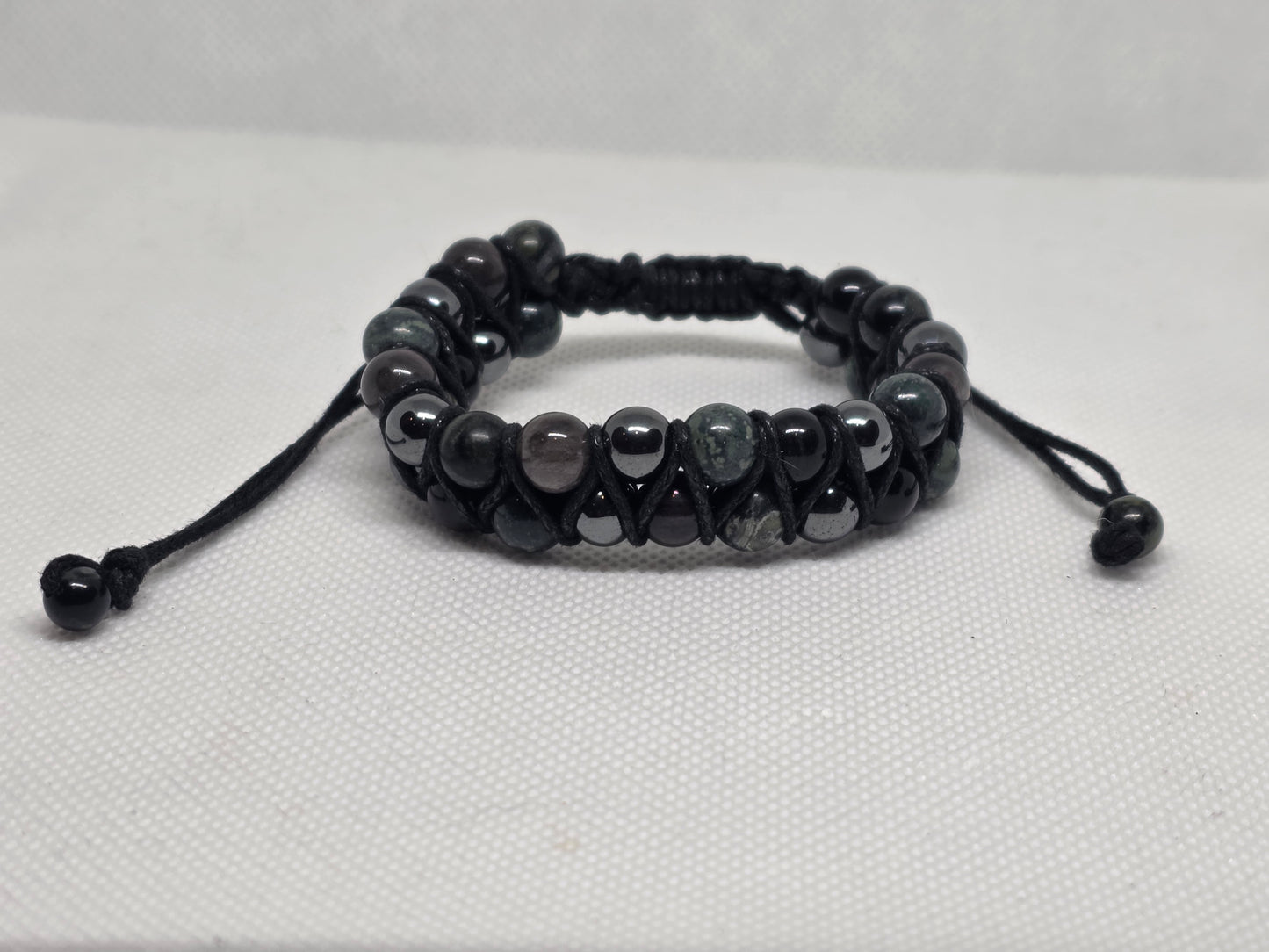 African turquoise, Obsidian and Hematite double strand bracelet on a white background