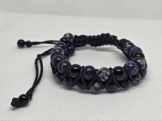 charoite, snowflake obsidian, and onyx adjustable beaded bracelet on a white background